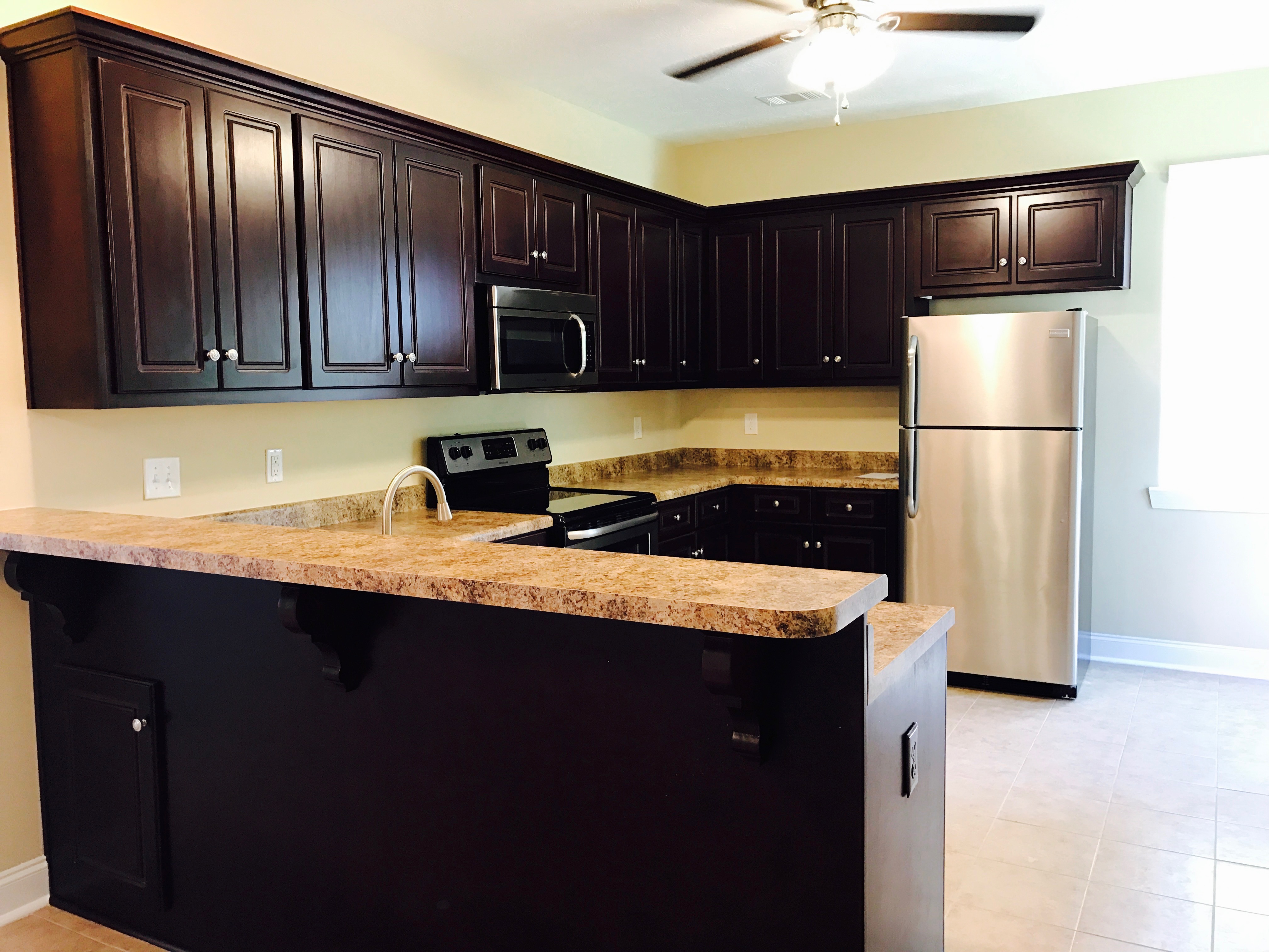 new kitchen with dark cabinets and breakfast bar general contractor augusta blount's complete home services fire water restoration termite pest control augusta ga